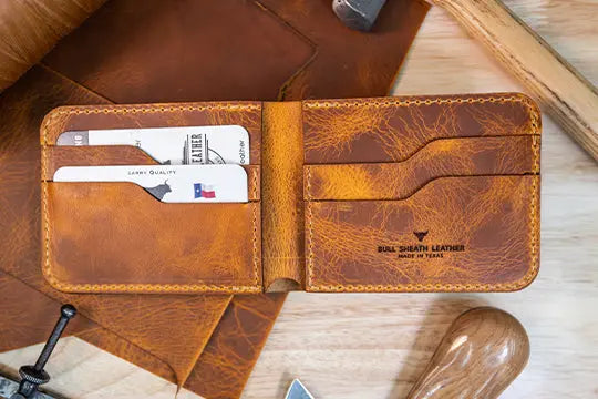 A brown leather bifold wallet, open to show ample space for storing cards and cash.