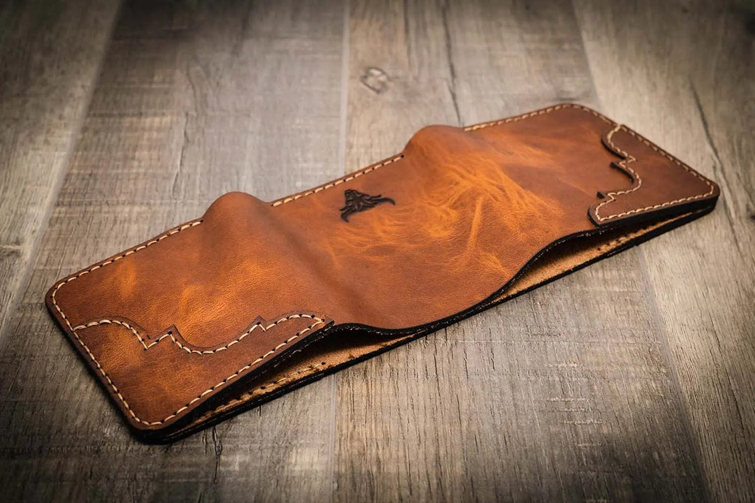 Trinity western trifold wallet in chestnut brown leather, facedown to show off the intricate stitching and a smooth finish, handmade in the USA.