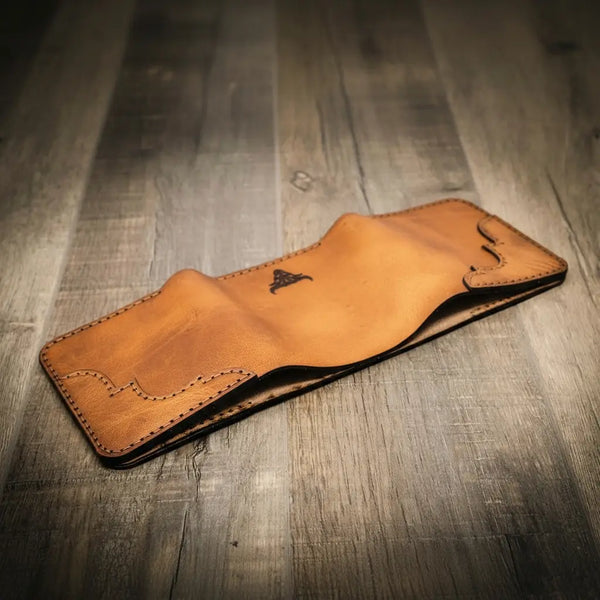 Trinity western trifold wallet in saddle tan leather, featuring intricate stitching and a smooth finish, handmade in the USA by Bull Sheath Leather.