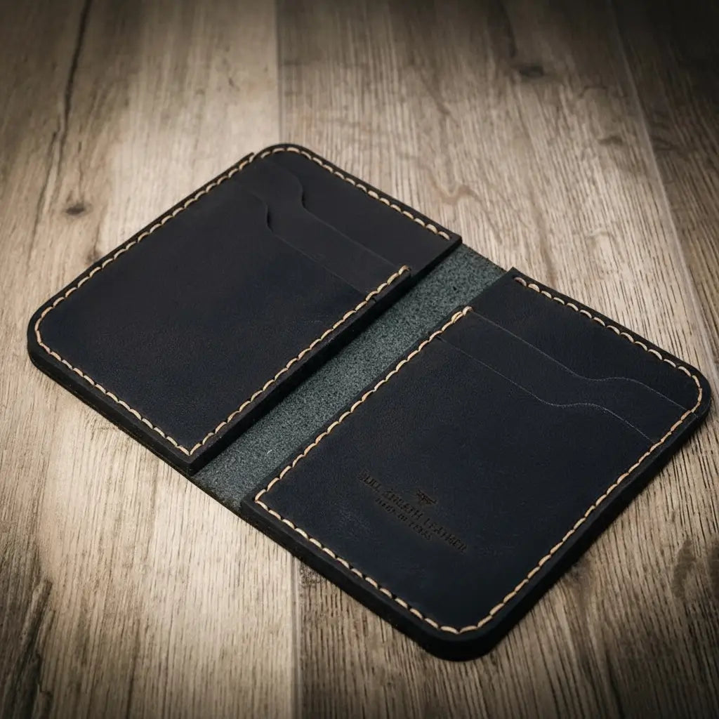 Handmade western vertical wallet in black leather, open to show stitching details and card slots.

