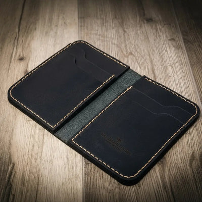 Handmade western vertical wallet in black leather, open to show stitching details and card slots.
