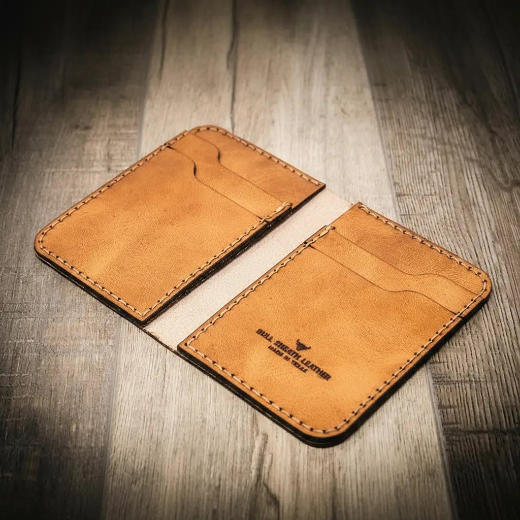 Handmade saddle tan leather wallet, in a vertical design, Bull Sheath Leather branding.
