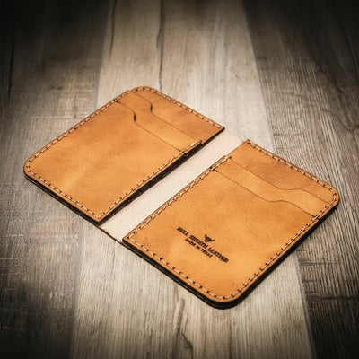 Handmade saddle tan leather wallet, in a vertical design, Bull Sheath Leather branding.
