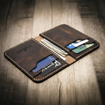 Handmade western vertical leather wallet in walnut brown color, open to show card slots and cash pocket.
