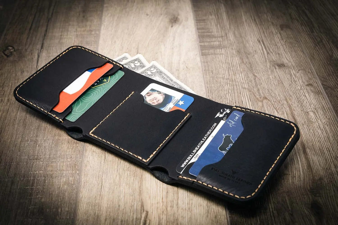 Trinity western trifold wallet in walnut brown leather, featuring multiple card slots and a cash compartment, displayed open with cards and cash inside.