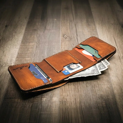 Trinity western trifold wallet in chestnut brown leather, open to display multiple card slots, an ID window, and a cash compartment, showcasing its handmade craftsmanship.
