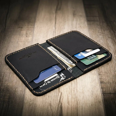 Western vertical wallet in black leather, with cards and cash inside. Handmade in Texas, USA
