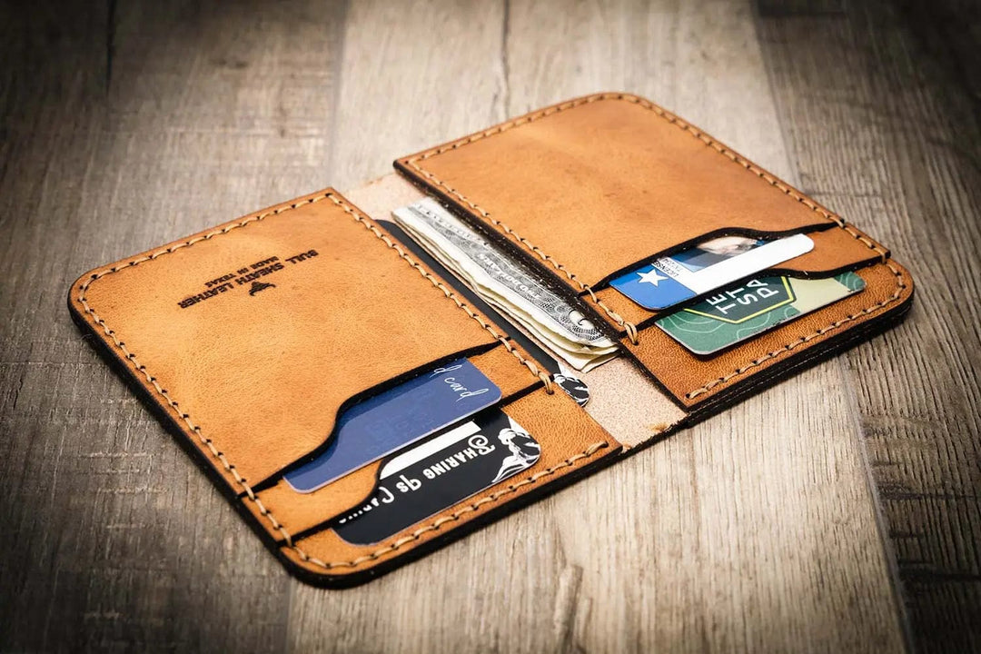 Western vertical wallet in saddle tan leather, handmade in the USA, with multiple card slots and cash pocket.