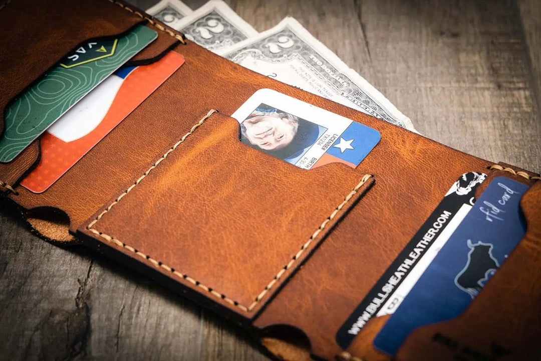 Trinity western trifold wallet in chestnut brown leather, featuring multiple card slots and a cash compartment, with visible stitching and a rustic finish.