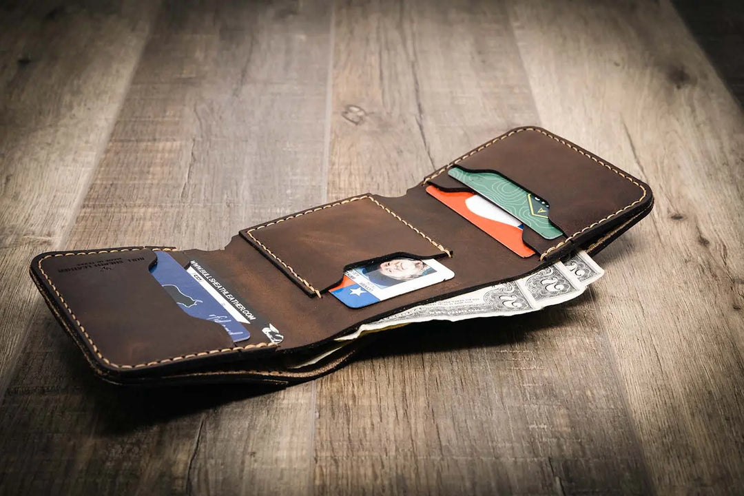 Trinity western trifold wallet in walnut brown leather, featuring multiple card slots and a cash compartment, displayed open with cards and cash inside.