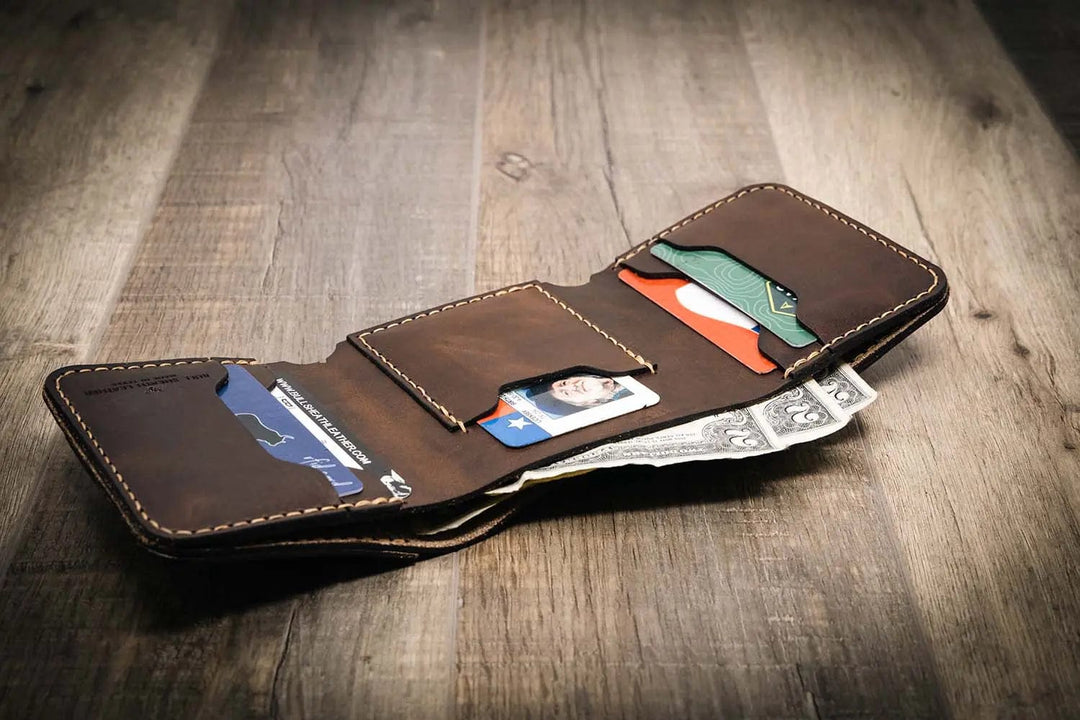 Trinity western trifold wallet in walnut brown leather, featuring multiple card slots and a cash compartment, displayed open with cards and cash inside.