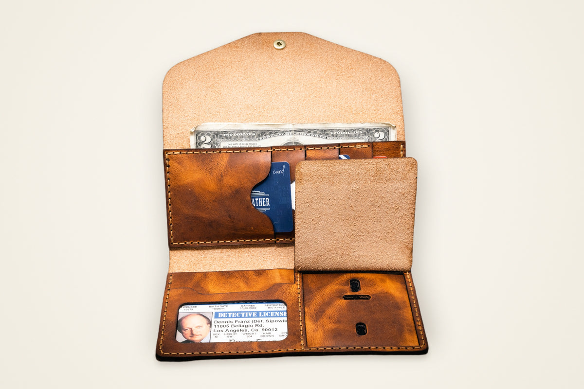 Badge Clutch Wallet on a cream background, showing its dedicated badge slot, multiple card slots, snap-closure cash compartment, hand-cut and stitched