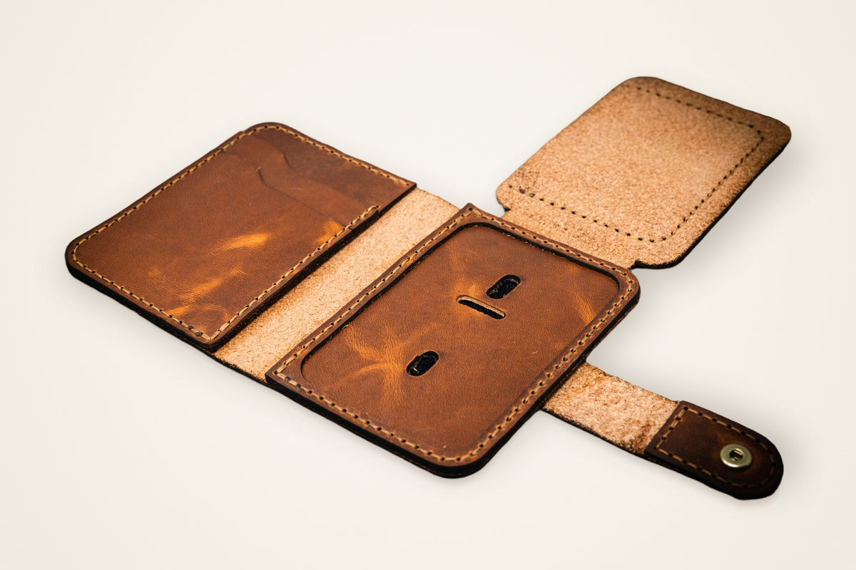 Badge Vertical Wallet on a cream background, showing its dedicated badge slot, two card slots, horween full-grain leather