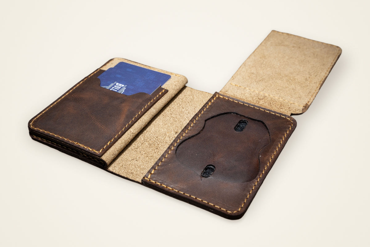 Federal Badge Wallets on a cream background, showing its recessed badge slot, card slots, horween full-grain leather, stitched, finished edges