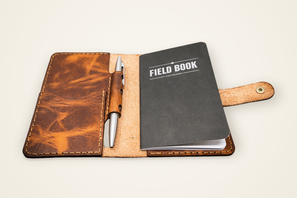 Leather Field Notes Cover on a cream background, showing its horween full-grain leather, card and id pocket, fits a standard field notes, front and back pockets