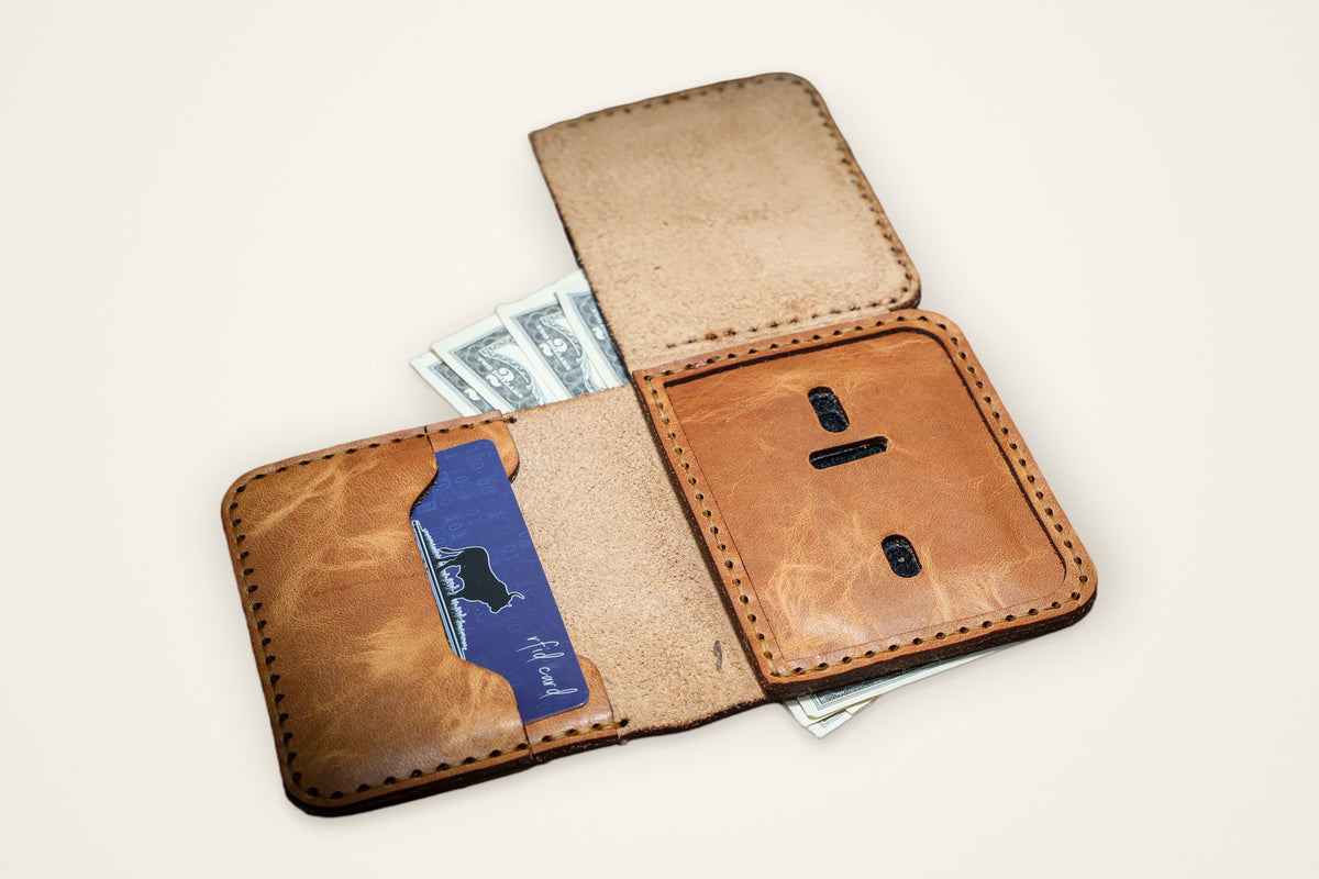 Minimalist Badge Wallet on a cream background, showing its dedicated badge slot, card slots for essentials, compact cash pocket, horween full-grain leather