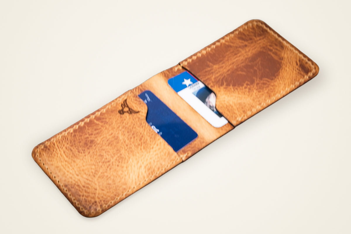 Peyton Small Card Holder on a cream background, showing its four card slots, horween full-grain leather, handmade in mansfield, texas