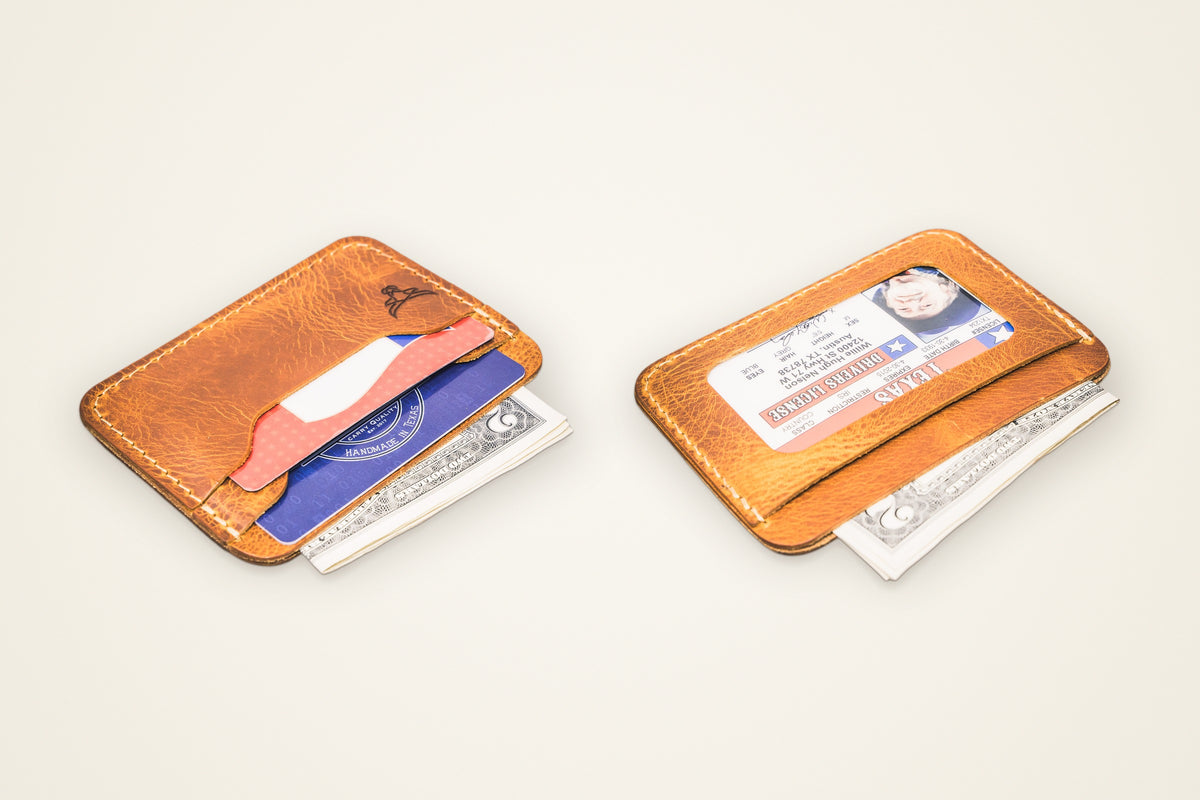 Pflugerville Card Wallet on a cream background, showing its two card slots, cash slot that also holds cards, id slot on the back, horween full-grain leather