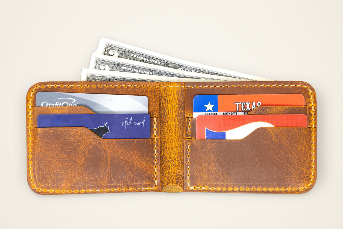 Rio Grande Bifold Wallet open on a cream background showing the cash compartment, four card slots and hidden vertical pockets