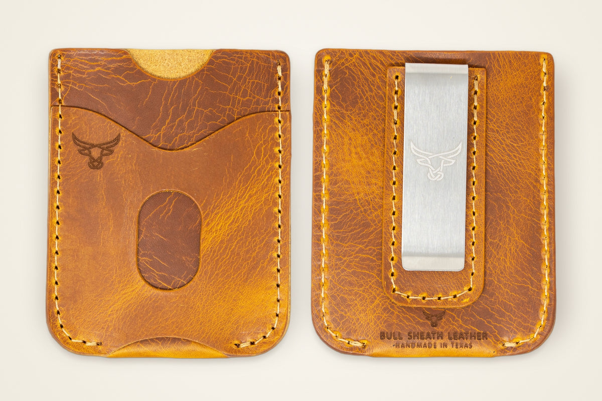 The Keller Money Clip on a cream background, showing its solid metal clip, two card slots each side, horween full-grain leather, handmade in mansfield, texas