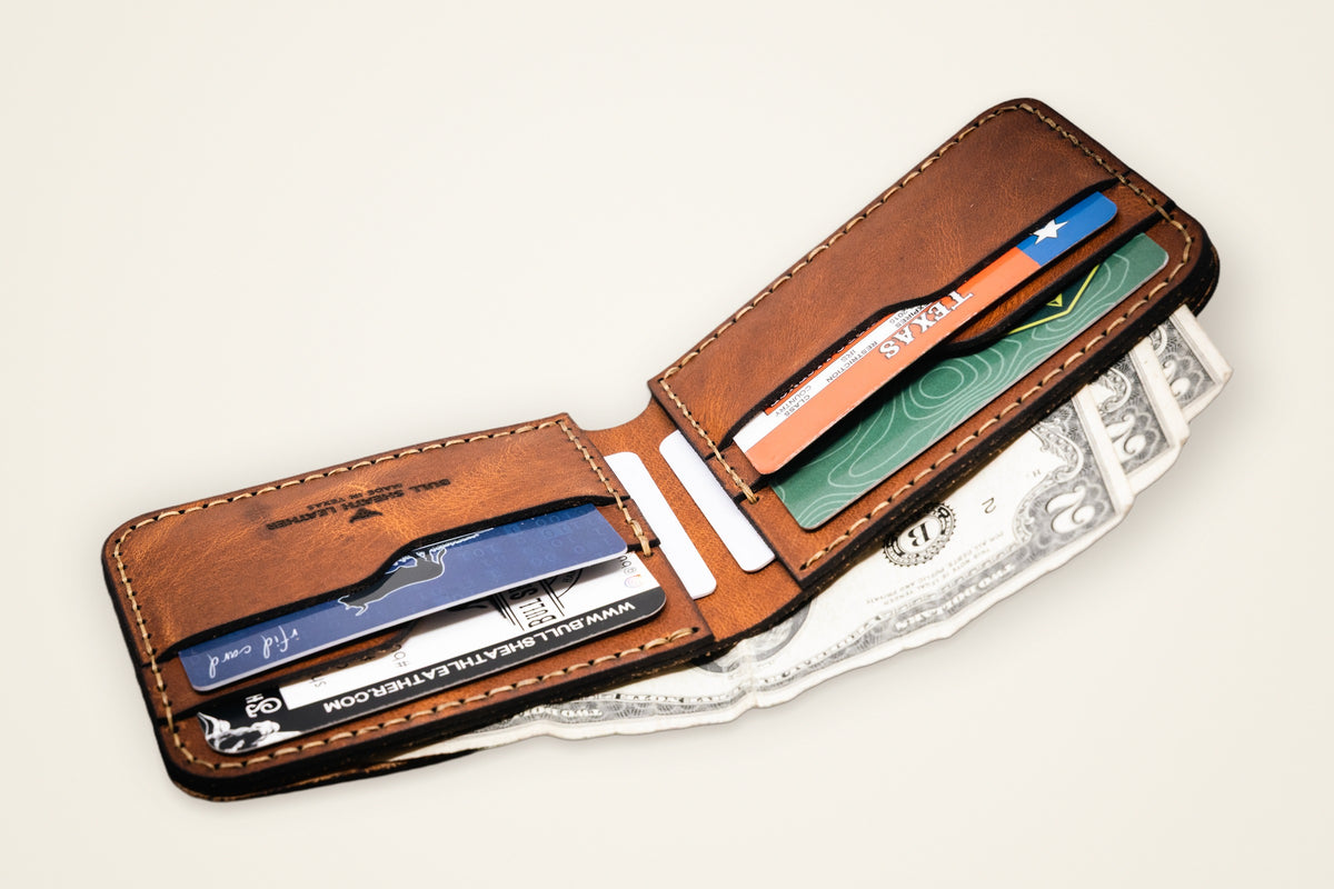 Western Bifold Wallet on a cream background, showing its six card slots, hidden vertical pockets, full-width cash pocket, horween full-grain leather
