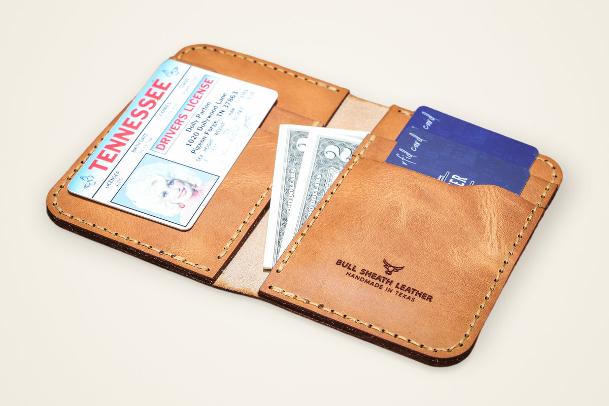 Western Vertical Wallet on a cream background, showing its four vertical card slots, two interior pockets, full-grain horween leather, handmade in mansfield, texas