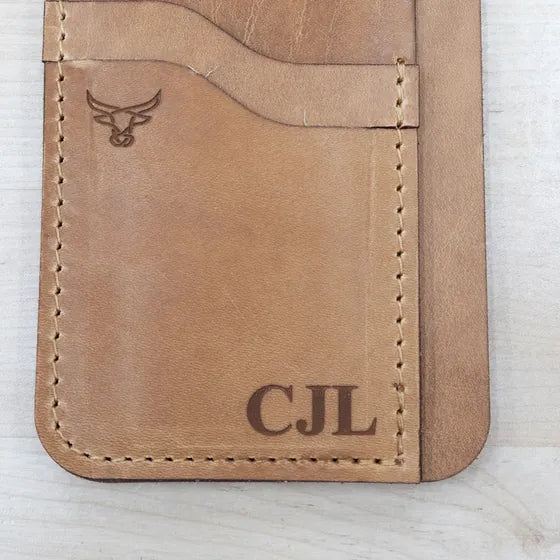 Tan leather card wallet with the initials CJL engraved in the lower right corner and the Bull Sheath bull logo at the upper left