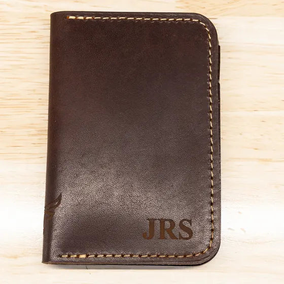 Dark brown leather wallet with the initials JRS engraved in the lower right corner