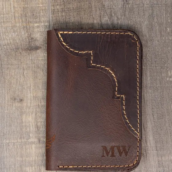 Dark brown leather wallet with a Western-style stitched cutout and the initials MW engraved in the lower right corner