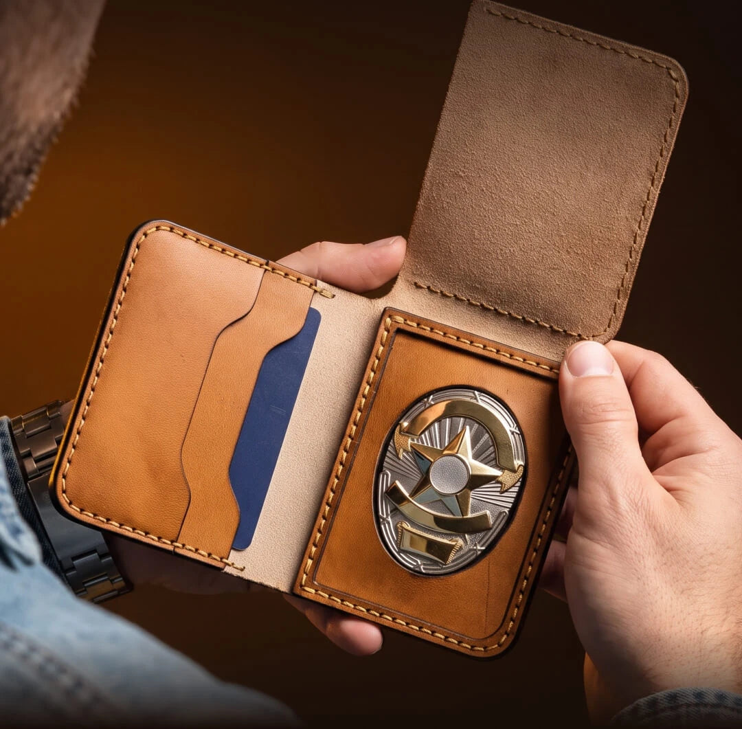 Hands holding an open leather badge wallet with a star badge