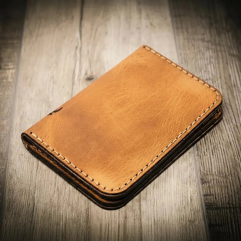 The Tyler Vertical Wallet in Saddle Tan, closed, showing its stitching and leather
