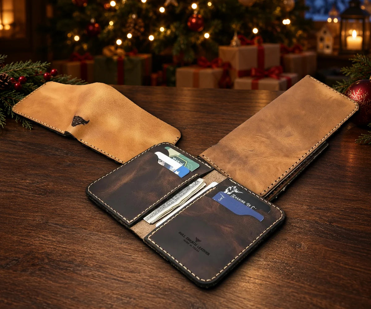 The Rio Grande Bifold, the Houstonian Long Wallet and the open Tyler Vertical Wallet together by a lit Christmas tree
