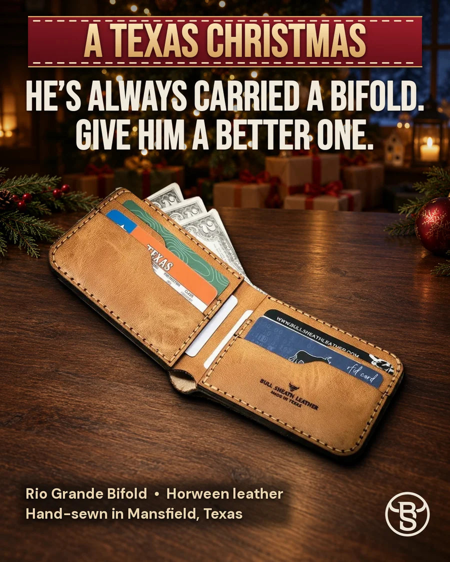He’s always carried a bifold. Give him a better one. The open Rio Grande Bifold in Saddle Tan by a Christmas tree